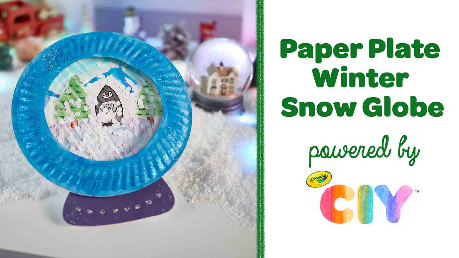 Homemade paper plate penguin snow globe on table with Paper Plate Winter Snow Globe powered by Crayola CIY