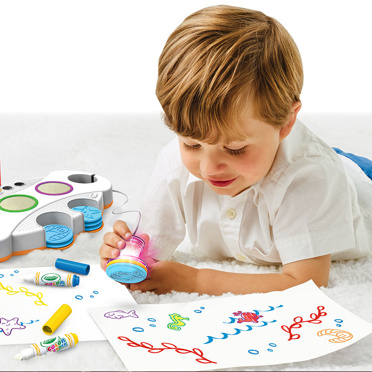 Kid using Color Wonder Stamps and Markers