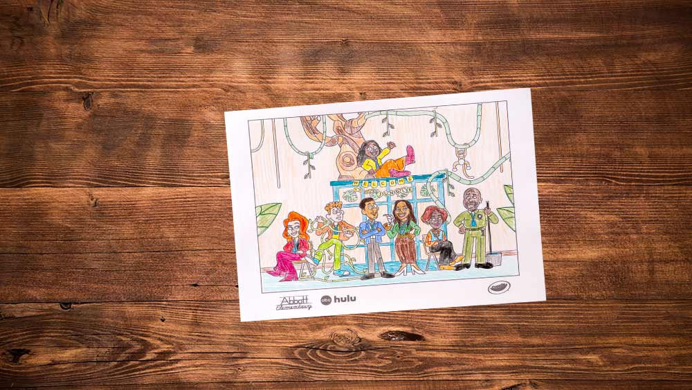 Completed Jungle classroom coloring page surrounded by crayons on a wooden table.