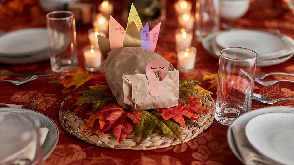 Paper bag turkey centerpiece on set dinning table.