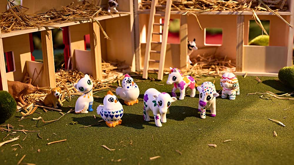 Assorted decorated scribble scrubbie farm animals in a barn setting.
