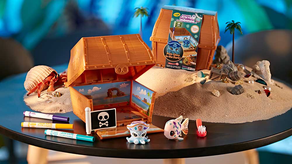 Scribble Scrubbie Ocean Treasure playset on table with pile of sand.