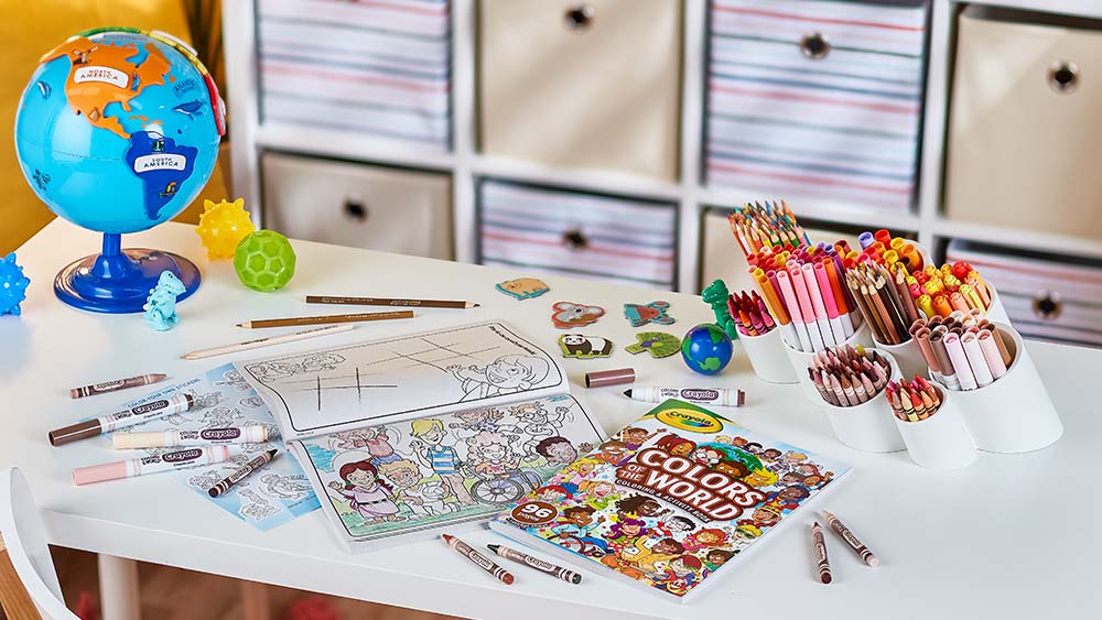 Coloring books and pads on a desk.