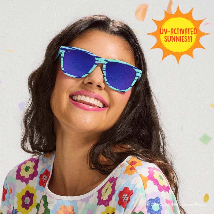 Crayola x goodr sunglasses confetti colors.  woman wearing pool party sunglasses.