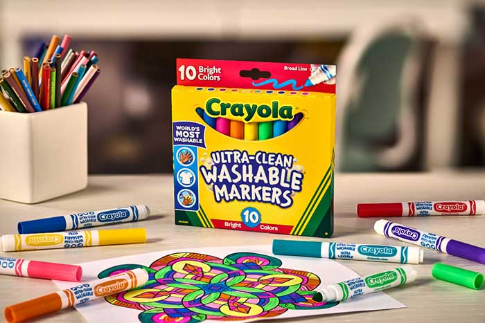 Ultra-Clean Markers, Broad Line, Bright, 10 ct.. markers on table with coloring page completed using markers strewn about.