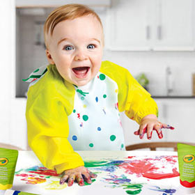 Toddler in Crayola Art Smock playing with Crayola Fingerpaints
